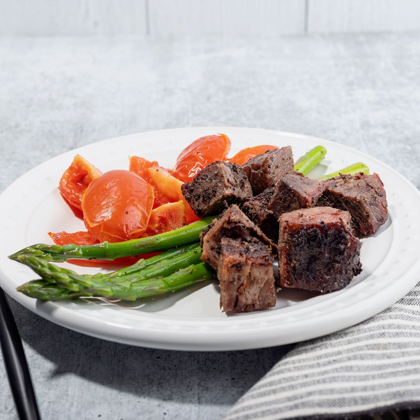 Peppercorn Crusted Brisket with Roasted Tomatoes and Asparagus