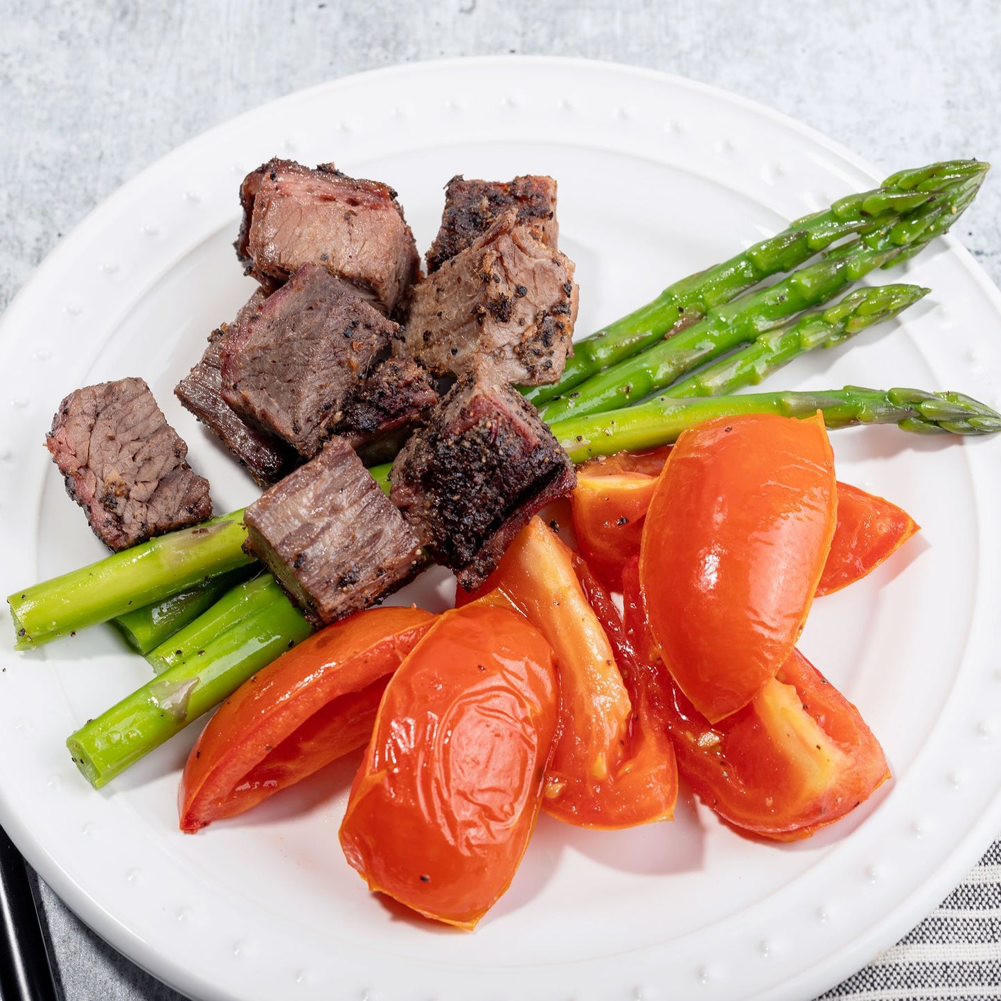 Peppercorn Crusted Brisket with Roasted Tomatoes and Asparagus