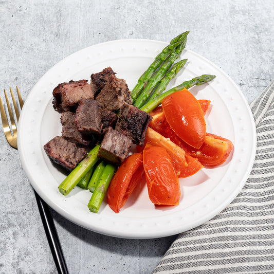 Peppercorn Crusted Brisket with Roasted Tomatoes and Asparagus